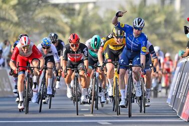 Ireland's Sam Bennett, right, celebrates as he crosses the finish line to win the fourth stage of the UAE tour cycling race, a sprint stage in Al Marjan Island, in Abu Dhabi, United Arab Emirates, Wednesday, Feb. 24, 2021. (Fabio Ferrari/LaPresse via AP)