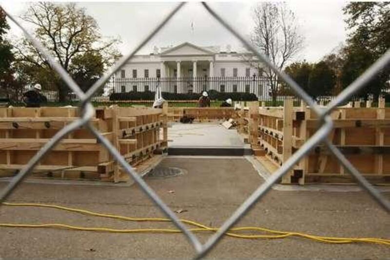 With the White House in the background, workers continue to build the presidential inauguration reviewing stand in Washington.