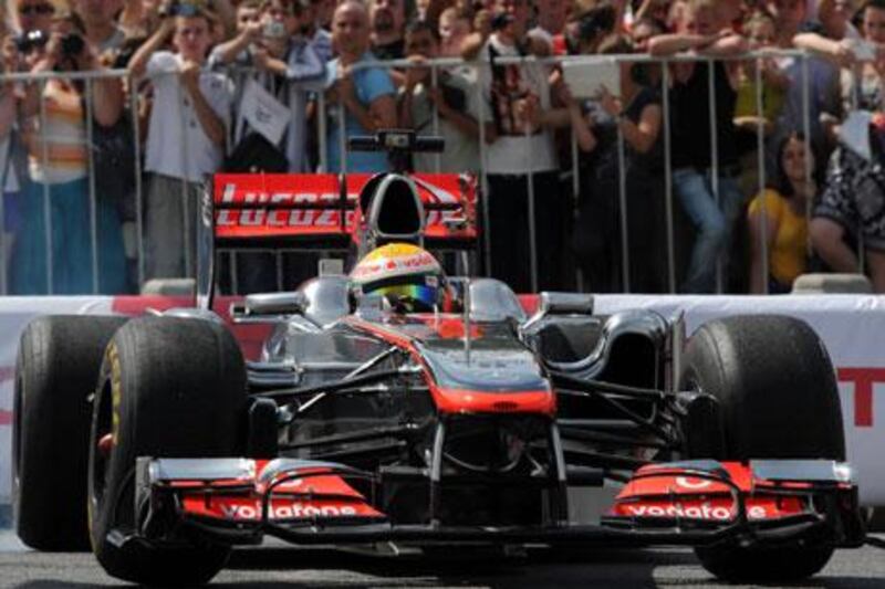 Lewis Hamilton shows off the McLaren during the Moscow City Racing show