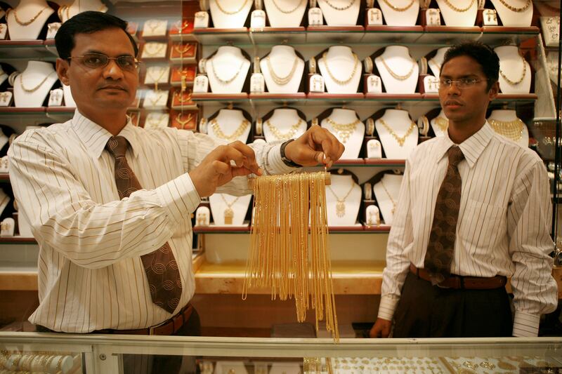 ABU DHABI, UNITED ARAB EMIRATES �� February 26, 2008: (left to right) Ketan Soni, and Antonio Pereira display gold necklaces at Kanz Jewelry store in the Gold Centre, Madinat Centre. The UAE Federal National Government opened discussions to have security guards in gold souks to carry firearms. (Photo by Ryan Carter / ADMC) *** Local Caption *** RC007-GoldCentre.jpg