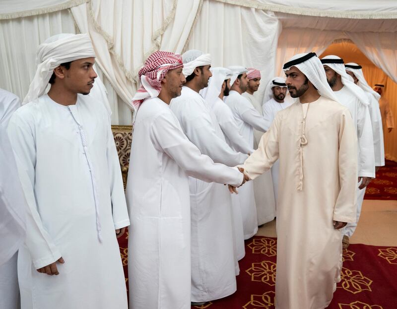 SHAWAMEKH, ABU DHABI, UNITED ARAB EMIRATES - September 15, 2019: HH Sheikh Khalifa bin Tahnoon bin Mohamed Al Nahyan, Director of the Martyrs' Families' Affairs Office of the Abu Dhabi Crown Prince Court (R), offers condolences to the family of martyr Warrant Officer Zayed Musllam Suhail Al Amri.

( Mohamed Al Hammadi / Ministry of Presidential Affairs )
---