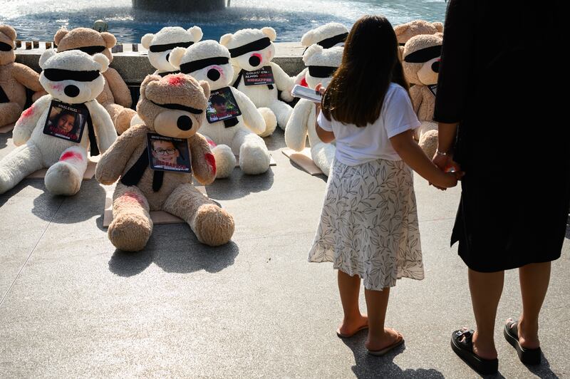 In Tel Aviv, teddy bears with their eyes covered and signs of injury go on show to highlight the young children and babies missing, believed to be being held by Hamas. Getty 