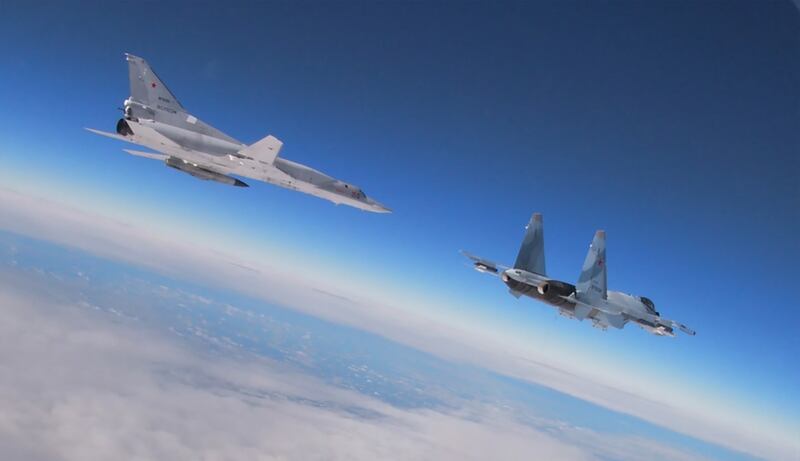 A Tupolev TU-22M3 Backfire strategic bomber, left, and an SU-35 multirole supermanoeuvrable fighter during exercises by Russia forces in February, 2022. AFP