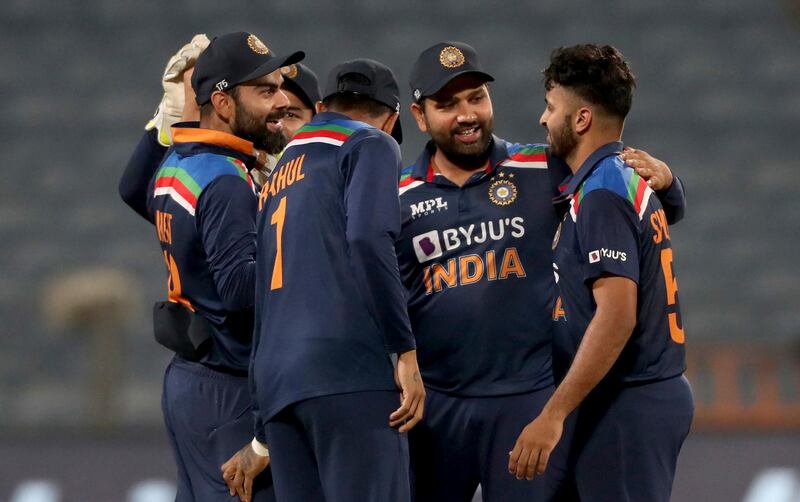 India's captain Virat Kohli, left, and Shardul Thakur, right celebrate with teammates the dismissal of England's Adil Rashid. AP