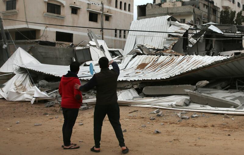 Palestinians inspect the damage of destroyed building belongs to Hamas ministry of prisoners hit by Israeli airstrikes. AP Photo
