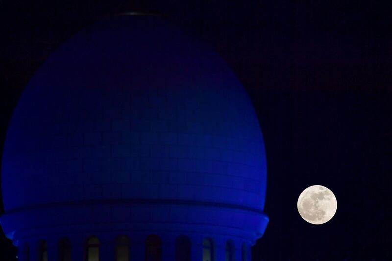 The "supermoon" rises over the Sheikh Zayed Grand Mosque in Abu Dhabi. Giuseppe Cacace / AFP