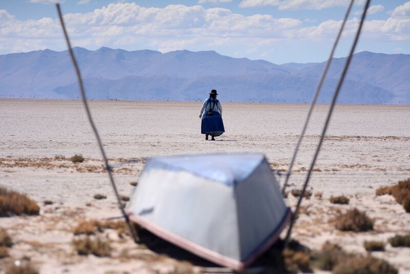Cristina Mamani in what was once Bolivia's second largest lake, Lake Poopo, which dried up because of water diversion for regional irrigation needs and a warmer, drier climate, according to residents and scientists.