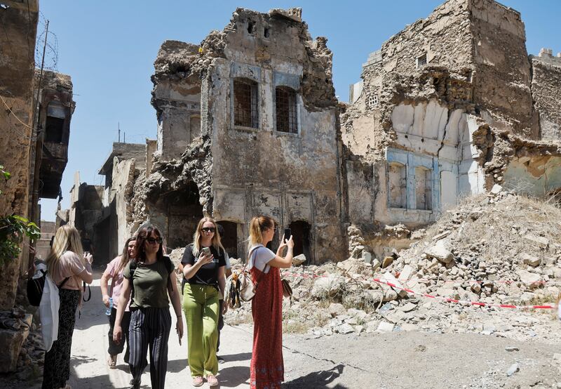 Foreign tourists walk inside Mosul's Old City in Iraq after the city's liberation from the Islamic State group. All photos: Reuters