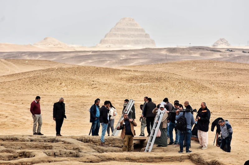 Reporters prepare to enter a recently discovered tomb near the famed Step Pyramid, in Saqqara.  AP