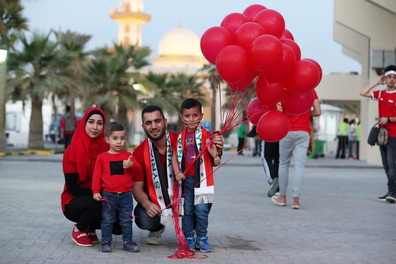 SHARJAH , UNITED ARAB EMIRATES , January  6 ��� 2019 :- Shadi Rihan with his wife Samah and son Zaid ( left ) and Ryan ( Right ) Syrian fans before the start of AFC Asian Cup UAE 2019 football match between Syria vs Palestine held at Sharjah Football Stadium in Sharjah. ( Pawan Singh / The National ) For News/Sports