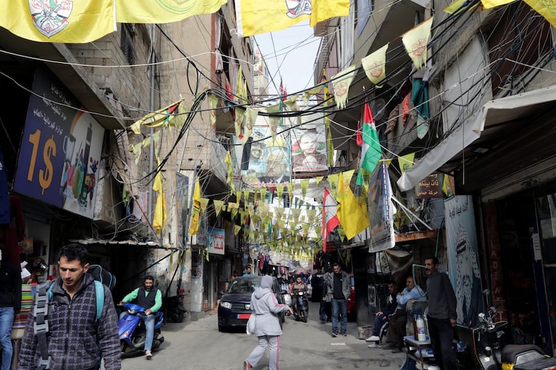 A picture taken on December 21, 2017 shows a view of posters showing Palestinian leaders and Fatah flags hanging in a street in the Burj al-Barajneh camp, a southern suburb of the Lebanese capital Beirut. - More than 174,000 Palestinian refugees live in Lebanon, authorities announced on December 21, in the first-ever census of its kind for a country where demographics have long been a sensitive subject.
The census was carried out by the government's Lebanese-Palestinian Dialogue Committee in 12 Palestinian camps as well as 156 informal "gatherings" across the country. (Photo by ANWAR AMRO / AFP)