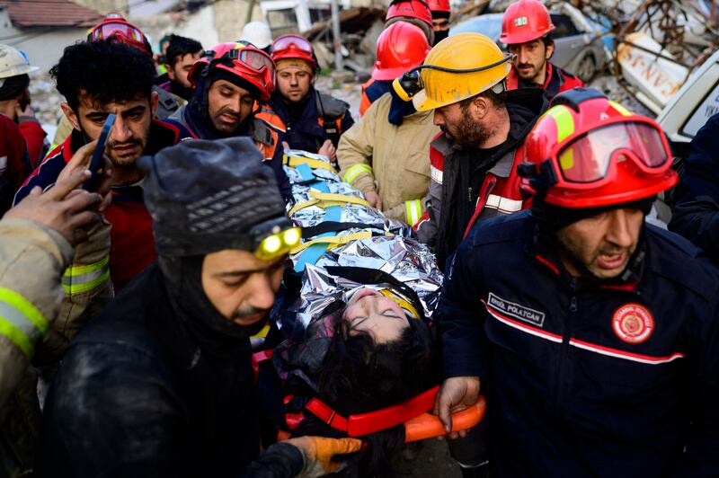 Rescuers pull out a 12-year-old Syrian girl, Cudi, from the rubble in Hatay. AFP