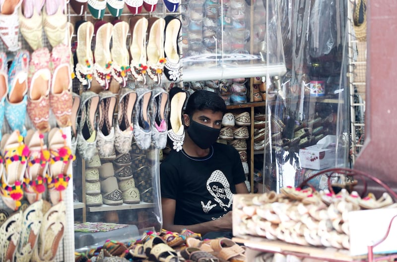 DUBAI, UNITED ARAB EMIRATES , May 6 – 2020 :- A salesman wearing protective face mask at his traditional shoes shop in Bur Dubai area in Dubai. UAE government ease the coronavirus restriction for the residents around the country. (Pawan Singh / The National) For News/Standalone/Online/Stock/Instagram