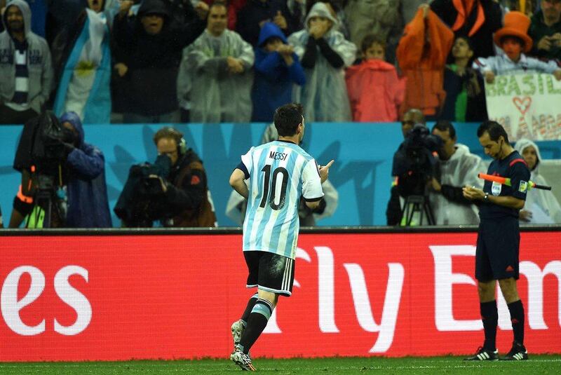 Lionel Messi celebrates after scoring his penalty shot in Argentina's 2014 World Cup semi-final victory over the Netherlands on Wednesday. Pedro Ugarte / AFP / July 9, 2014