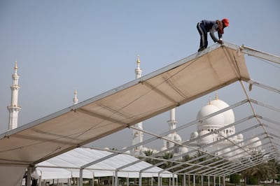 Abu Dhabi, United Arab Emirates, June 18, 2013: 
Al Aydi Metal Industries Factory employees work on setting up iftar tents on Tuesday afternoon, June 18, 2013, at the Sheikh Zayed Grand Mosque grounds in Abu Dhabi. There will be a total on ten large tents and two smaller ones, which will house the kitchens.
Silvia Razgova / The National

ATTN:  

 *** Local Caption ***  sr-130618-iftartents08.jpg
