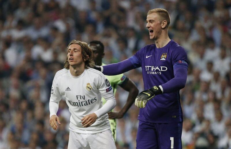 Real Madrid midfielder Luka Modric, left, and Manchester City goalkeeper Joe Hart. Sergio Perez / Reuters