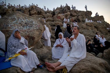 Muslim pilgrims pray at Jabal Al Rahma holy mountain, or the mountain of forgiveness, at Arafat for the annual hajj pilgrimage, outside the holy city of Mecca, Saudi Arabia, Monday, Aug. 20, 2018. More than 2 million Muslims have begun the annual hajj pilgrimage, one of the five pillars of Islam which is required of all able-bodied Muslims once in their lifetime. (AP Photo/Dar Yasin)
