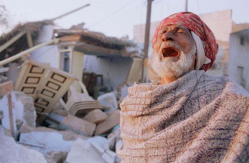 384982 03: A Muslim man weeps in front of his destroyed house January 29, 2001 in Bhuj, India. Bhuj and the surrounding villages in the western Indian state of Gujarat lay at the epicenter of Friday''s earthquake, which registered 7.9 on the Richter scale. Few structures remain standing amidst the rubble. (Photo by Alyssa Banta/Newsmakers)