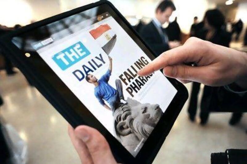 A journalist looks at the front page of The Daily, an electronic newspaper designed for the iPad, after its launch was announced at the Guggenheim Museum in New York. AFP PHOTO/Stan Honda