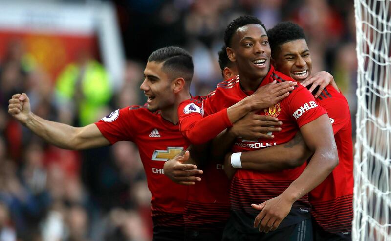 Manchester United's Anthony Martial, center, celebrates scoring his side's second goal of the game during the English Premier League soccer match between Manchester United and Watford at Old Trafford Stadium, Manchester, England. Saturday, March. 30, 2019. (Martin Rickett/PA via AP)