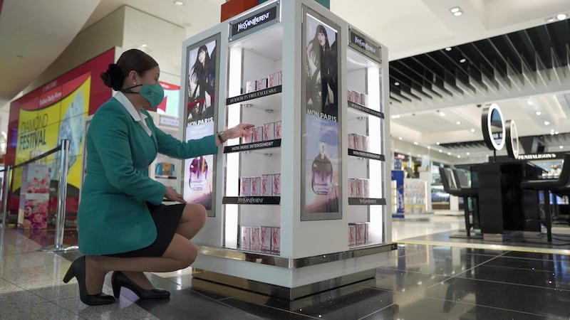 Dubai Duty Free staff restock shelves ahead of the first flights resuming