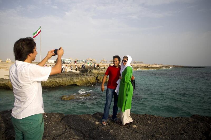 An Iranian couple take a picture of themselves at beach on Kish Island. AFP