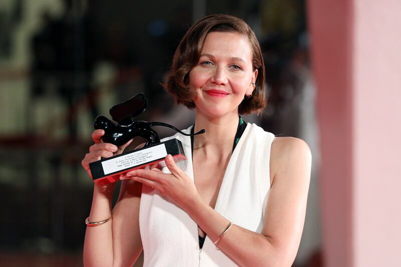 Maggie Gyllenhaal poses with the award for Best Screenplay for 'The Lost Daughter'. Getty Images