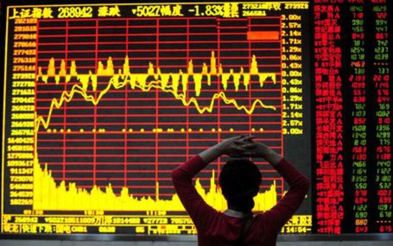 A Chinese woman monitors stock prices on a display board at a brokerage house in Hefei in central China's Anhui province on Friday, May 7, 2010.