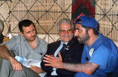 United Arab Emirates (UAE) Defense Minister Mohamad ibn Rashid al-Maktoum (R) chats with Egyptian actor Omar Sharif (C) and Bashar al-Assad son of Syrian President Hafez al-Assad as they meet in a tent in the historic city of Palmyra north east of Damascus 05 May 1999. Al-Maktoum is taking part in a desert horse race, a part of a festival in this ancient city. (Photo by Louai Beshara / AFP)