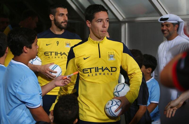 Samir Nasri enters the pitch to Wednesday's training session for Manchester City at Al Jazira's Mohammed bin Zayed Stadium in Abu Dhabi. Man City will play Al Ain on Thursday night. Marwan Naamani / AFP / May 14, 2014 