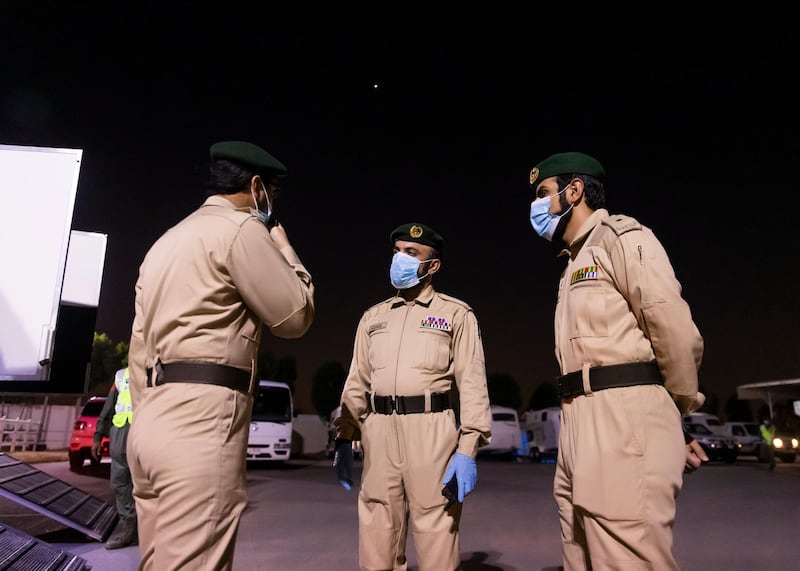 DUBAI, UNITED ARAB EMIRATES. 16 APRIL 2020. Dubai Mounted Police officers, in Al Aweer, prepare to load the horses into the trailer, as they prepare to patrol residential and commercial areas to insure residents are staying safe indoors during COVID-19 lockdown. They patrol the streets from 6PM to 6AM.The officers of the Dubai Mounted Police unit have been playing a multifaceted role in the emirate for over four decades. The department was established in 1976 with seven horses, five riders and four horse groomers. Today it has more than 130 Arabian and Anglo-Arabian horses, 75 riders and 45 groomers.All of the horses are former racehorses who went through a rigorous three-month-training programme before joining the police force. Currently, the department has two stables – one in Al Aweer, that houses at least 100 horses, and the other in Al Qusais, that houses 30 horses.(Photo: Reem Mohammed/The National)Reporter:Section: