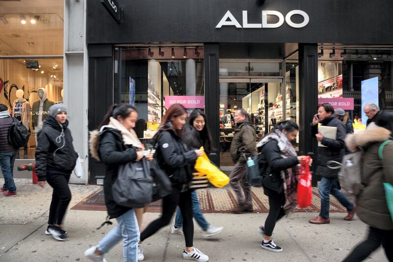 Shoppers pass in front of an Aldo Group Inc. store in the SoHo neighborhood of New York, U.S., on Friday, Feb. 9, 2018. Bloomberg is scheduled to release consumer comfort figures on February 15. Photographer: Sarah Blesener/Bloomberg