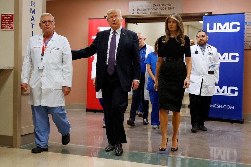 President Donald Trump and first lady Melania Trump walk through University Medical Center after meeting with victims of the mass shooting. Evan Vucci / AP Photo