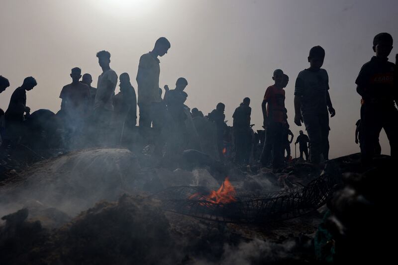 Palestinians gather at the site of an Israeli strike on a refugee camp in Rafah. AFP
