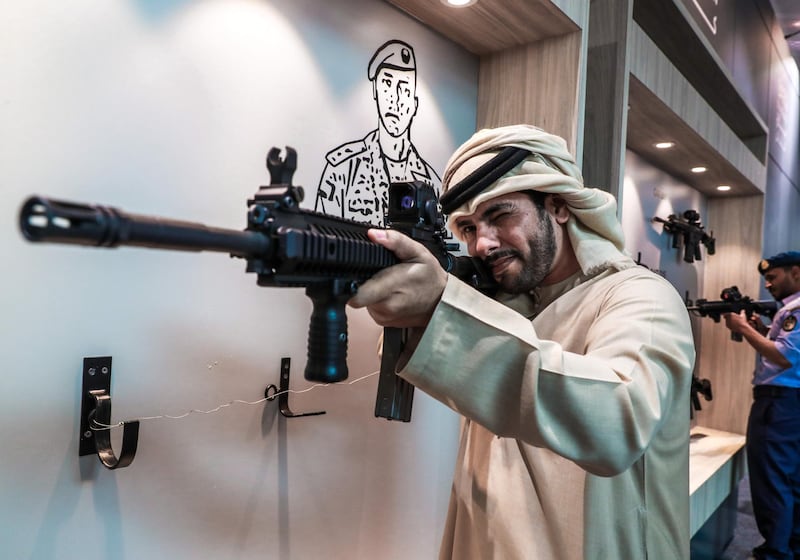 Abu Dhabi, U.A.E., February 20, 2019. INTERNATIONAL DEFENCE EXHIBITION AND CONFERENCE  2019 (IDEX) Day 4--  Colour images.-- A visitors at the show look at the Sultan assault rifle..
Victor Besa/The National
Section:  NA