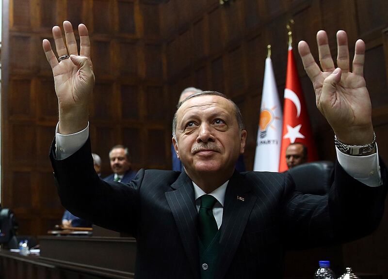 Turkey's President Recep Tayyip Erdogan salutes as he addresses his ruling Justice and Development Party members at the parliament in Ankara, Turkey, Tuesday, March 6, 2018.(Kayhan Ozer/Pool Photo via AP)