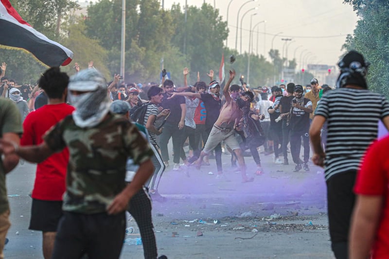 Riot police use tear gas to prevent protesters from storming the Iraqi Parliament Representation Building during anti-government demonstrations in Basra, Iraq, Tuesday, June 16, 2020. (AP Photo/Nabil al-Jurani)