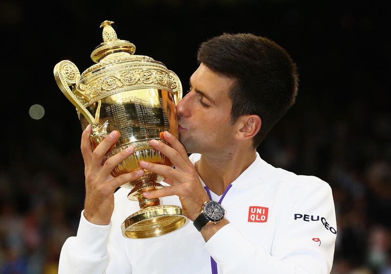 LONDON, ENGLAND - JULY 12:  Novak Djokovic of Serbia celebrates with the trophy after winning the Final Of The Gentlemen's Singles against Roger Federer of Switzerland on day thirteen of the Wimbledon Lawn Tennis Championships at the All England Lawn Tennis and Croquet Club on July 12, 2015 in London, England.  (Photo by Clive Brunskill/Getty Images)