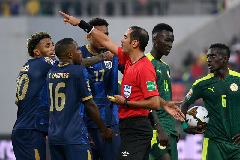 Cape Verde's forward Ryan Mendes Da Graca, left, and defender Dylan Tavares argue with Algerian referee Lahlou Benbraham. AFP