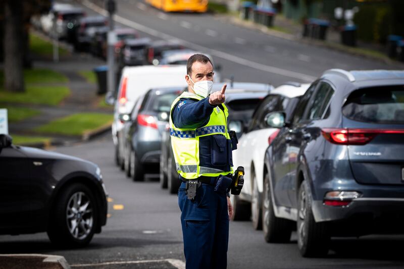 Police control the long vehicle line waiting for Covid-19 testing in Auckland on August 19, 2021. AP Photo