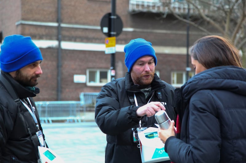  Liam and Danny, fundraisers for TAP London, a company that employs homeless people to raise money for homeless charities via contactless payments, speak to a passer-by in London United Kingdom on January 4, 2018. Thomson Reuters Foundation / Cormac O'Brien