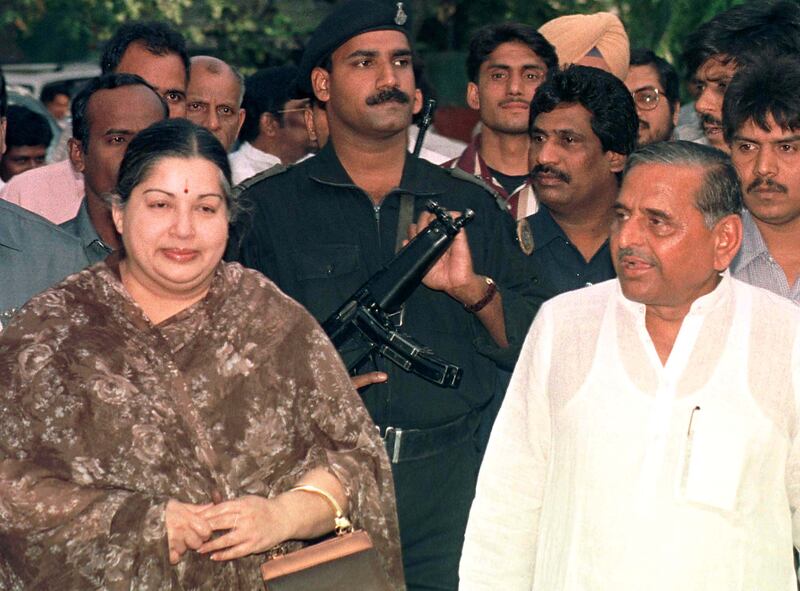 Jayaram Jayalalitha, left, leader of the regional AIADMK party, and Yadav pose for photographers before the start of a meeting in New Delhi in April 1999. Reuters