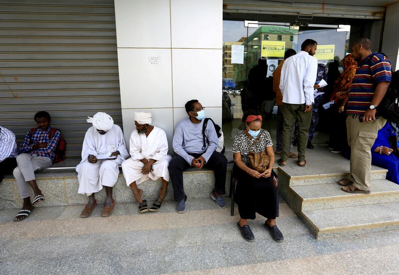 People outside an exchange bureau in Khartoum.  The International Monetary Fund has approved a $2.5 billion extended credit line for Sudan. Reuters