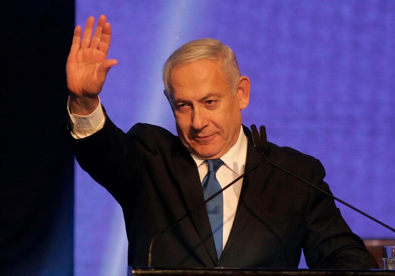 Israeli Prime Minister Benjamin Netanyahu waves as he addresses supporters at his Likud party's electoral campaign headquarters early on September 18, 2019. Israeli Prime Minister Benjamin Netanyahu said he was waiting for results in the country's general election, but that he was prepared for negotiations to form a "strong Zionist government." He spoke as exit polls showed a tight race between his right-wing Likud and ex-military chief Benny Gantz's centrist Blue and White alliance. / AFP / Menahem KAHANA
