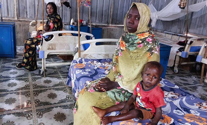 Women and a children waiting at a nutrition centre at the Kalma camp for the displaced outside Nyala, the provincial capital of South Darfur state. AFP