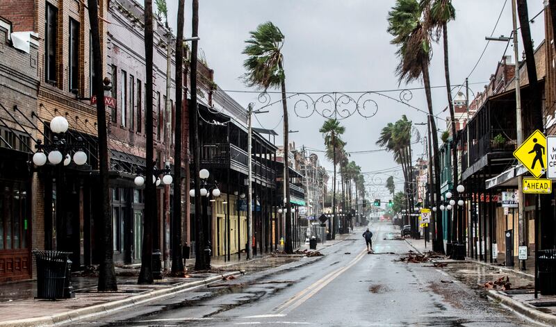 A man stands in the middle of 7th Street in Ybor City a few hours before the high winds hit Tampa. AP
