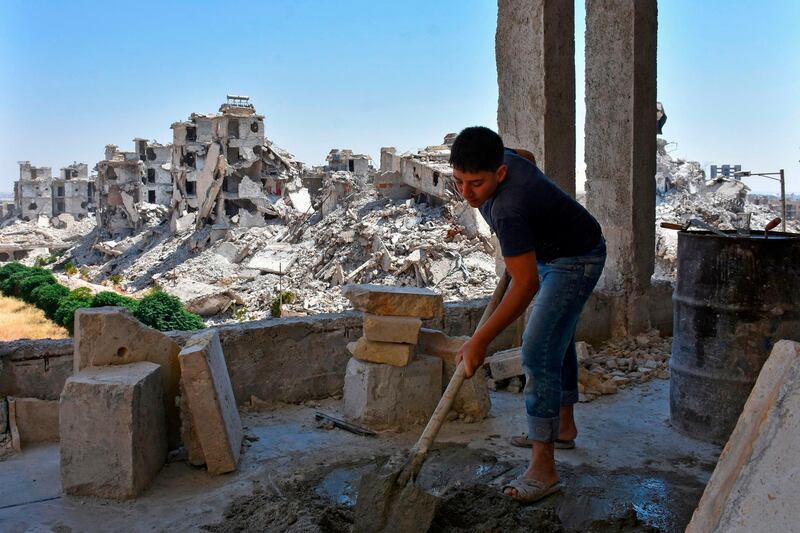 A labourer works in Al Zahraa neighbourhood of Aleppo as residents reconstruct their damaged homes following years of conflict in Syria.  AFP