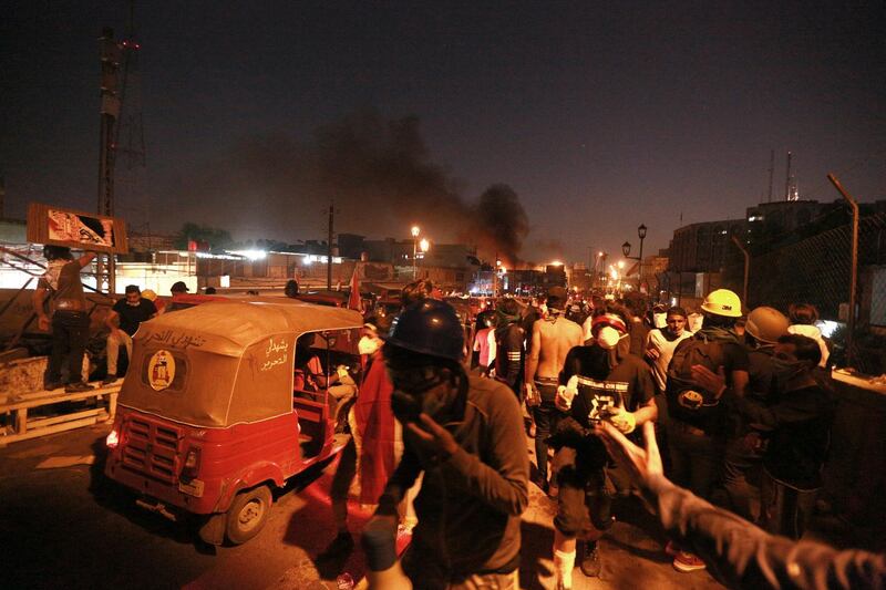 Iraqi security forces fired live ammunition and tear gas while anti-government protests gather near the state-run TV in Baghdad, Iraq. AP Photo