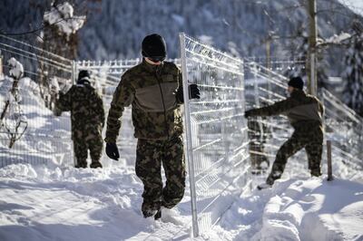 Military personnel build a security barrier before leaders descend on Davos in Switzerland. EPA 