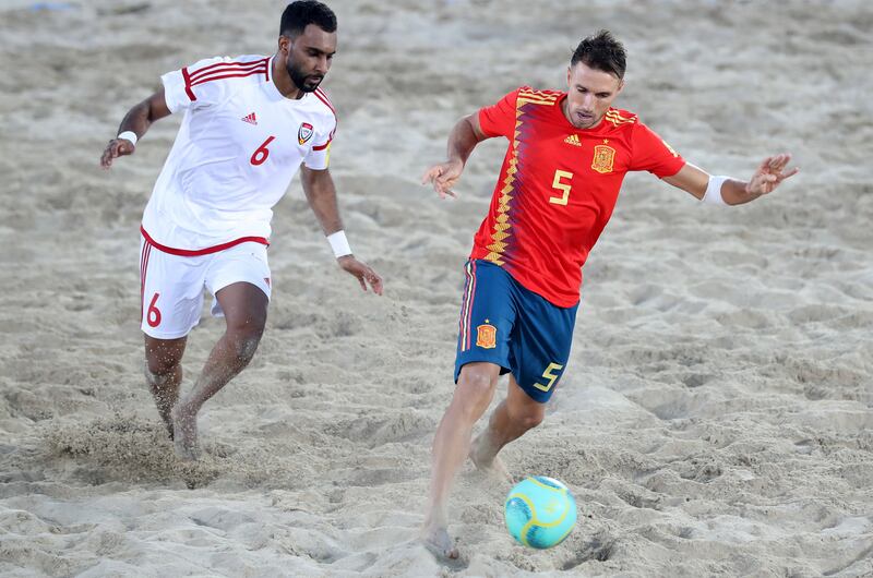 Dubai, United Arab Emirates - November 05, 2019: The UAE's Kamal Ali and Spain's Francisco Jose Cintas battle during the game between the UAE and Spain during the Intercontinental Beach Soccer Cup. Tuesday the 5th of November 2019. Kite Beach, Dubai. Chris Whiteoak / The National